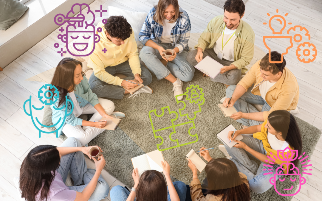 Grupo sentado en círculo tomando notas
